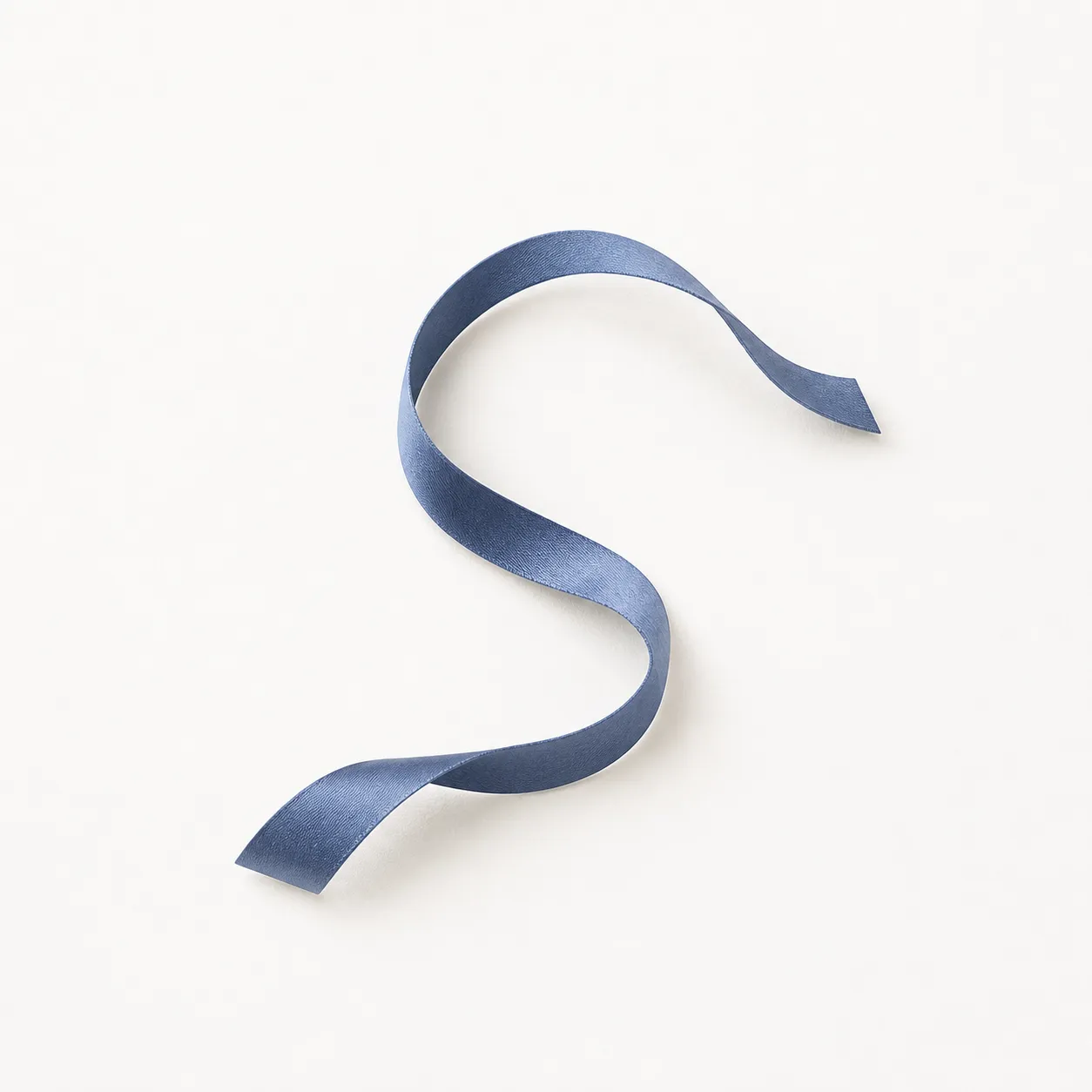 Abstract denim-blue ribbon flowing in an open loop on a warm off-white surface.